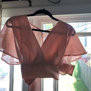 pink top with open back and bow tie